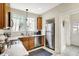 Modern kitchen featuring stainless steel appliances, wooden cabinets, and a window above the sink at 4029 Broadway St, Indianapolis, IN 46205