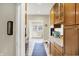 Galley kitchen featuring wood cabinets, granite countertops, and modern appliances at 4029 Broadway St, Indianapolis, IN 46205