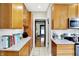 Bright kitchen featuring wood cabinetry, stainless steel microwave, granite countertops, and modern appliances at 4029 Broadway St, Indianapolis, IN 46205