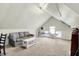 Finished attic space featuring neutral walls, carpeting, couch, and table tennis setup at 4029 Broadway St, Indianapolis, IN 46205