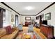 Spacious living room with hardwood floors, modern furniture, and a piano in the background at 4029 Broadway St, Indianapolis, IN 46205