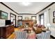 Cozy living room with a brick fireplace, hardwood floors, and lots of natural light at 4029 Broadway St, Indianapolis, IN 46205