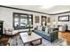 Inviting living room featuring a comfortable sofa, classic hardwood floors, and bright natural light at 4029 Broadway St, Indianapolis, IN 46205
