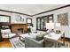 Comfortable living room with decorative fireplace, hardwood floors, and updated furniture at 4029 Broadway St, Indianapolis, IN 46205