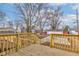 Back porch view showing a gray house with a new wood porch and a fenced backyard at 4804 Brouse Ave, Indianapolis, IN 46205