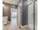 This bathroom showcases a glass enclosed shower, wood look tile and neutral paint at 4804 Brouse Ave, Indianapolis, IN 46205