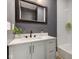 This bathroom includes a dark framed mirror, vanity with sink, and white tiled shower at 4804 Brouse Ave, Indianapolis, IN 46205