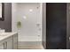 This bathroom features a white tiled shower, dark accent wall, and vanity at 4804 Brouse Ave, Indianapolis, IN 46205