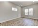 Well-lit bedroom with wood flooring, trim, and double-pane windows at 4804 Brouse Ave, Indianapolis, IN 46205