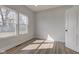 Sun-filled bedroom featuring wood floors, double windows, and ample natural light at 4804 Brouse Ave, Indianapolis, IN 46205