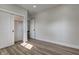 This bedroom has wood look flooring, a closet with doors, and a door to the hallway at 4804 Brouse Ave, Indianapolis, IN 46205