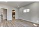 Bedroom featuring wood floors, natural light, and door leading to the bathroom at 4804 Brouse Ave, Indianapolis, IN 46205