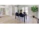 Dining room features a modern black table and chairs, with natural light from the nearby glass doors at 4804 Brouse Ave, Indianapolis, IN 46205