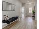 Inviting entryway with wood-look floors, bench seating, and decorative mirror adding character to the home at 4804 Brouse Ave, Indianapolis, IN 46205