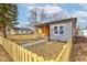 View of charming home with siding and a cute front porch protected by a picket fence beneath a cloudy sky at 4804 Brouse Ave, Indianapolis, IN 46205
