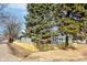 View of charming home with siding and a cute front porch screened by mature landscaping and a picket fence at 4804 Brouse Ave, Indianapolis, IN 46205