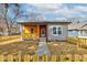 Charming single-story home features a mix of siding and a lovely front porch, surrounded by a cute picket fence at 4804 Brouse Ave, Indianapolis, IN 46205