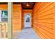 The wood paneled porch leads to a white front door, offering a warm welcome to the charming single-story home at 4804 Brouse Ave, Indianapolis, IN 46205