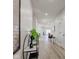 Long hallway showcasing the home's layout with wood-look floors, neutral walls, and recessed lighting at 4804 Brouse Ave, Indianapolis, IN 46205
