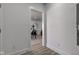 Hallway view of dining room featuring wood floors and a decorative wreath over the dining table at 4804 Brouse Ave, Indianapolis, IN 46205