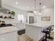 The modern white kitchen features stainless appliances, sleek countertops, and stylish pendant lighting at 4804 Brouse Ave, Indianapolis, IN 46205