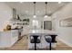 The kitchen features stainless steel appliances, granite countertops, white cabinetry, and a stylish kitchen island at 4804 Brouse Ave, Indianapolis, IN 46205
