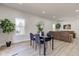 A view of the open-concept living area and dining space, featuring modern decor and new wood floors at 4804 Brouse Ave, Indianapolis, IN 46205