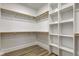 This walk-in closet has multiple wood closet rods and built in shelving for organization at 4804 Brouse Ave, Indianapolis, IN 46205