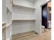 This closet is a walk-in closet with wood closet rods, built-in shelving, and flooring at 4804 Brouse Ave, Indianapolis, IN 46205