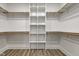 This is a walk-in closet featuring built-in shelving and wood closet rods at 4804 Brouse Ave, Indianapolis, IN 46205