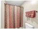 Bathroom showcasing a patterned shower curtain and neutral-colored walls with matching towels at 4947 Cherryhill Ct, Indianapolis, IN 46254