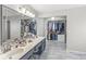 Large bathroom featuring a double vanity and spacious walk-in closet with custom shelving at 4947 Cherryhill Ct, Indianapolis, IN 46254