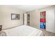 Bedroom with neutral-colored walls, carpet, and storage featuring an open doorway to the staircase at 4947 Cherryhill Ct, Indianapolis, IN 46254