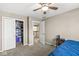 Bedroom with neutral walls and carpet, featuring a ceiling fan and a closet storage at 4947 Cherryhill Ct, Indianapolis, IN 46254