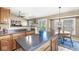 Bright eat-in kitchen with granite countertops, a dining table and a sliding door at 4947 Cherryhill Ct, Indianapolis, IN 46254