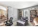 Comfortable office space with a relaxing chair, bookshelves, and a bright window view at 4947 Cherryhill Ct, Indianapolis, IN 46254