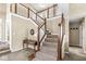 Elegant staircase with carpeted steps and a decorative wooden railing in a two story foyer at 4947 Cherryhill Ct, Indianapolis, IN 46254