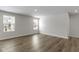 An empty bedroom featuring wood floors and two windows at 5147 Gerhing Dr, Indianapolis, IN 46239