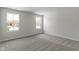 This bedroom is spacious and bright, featuring two windows and neutral carpeting at 5147 Gerhing Dr, Indianapolis, IN 46239