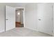 An open door in a bedroom with neutral carpet leads to the front door of the house at 5147 Gerhing Dr, Indianapolis, IN 46239