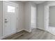 Modern and bright hallway featuring with light vinyl floors, and white trim at 5147 Gerhing Dr, Indianapolis, IN 46239