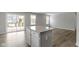 Bright kitchen featuring sliding doors, granite countertops, and an island with a breakfast bar at 5147 Gerhing Dr, Indianapolis, IN 46239