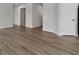 Living room with wood floors and doors leading into other rooms at 5147 Gerhing Dr, Indianapolis, IN 46239