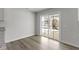 Living room with wood floors and a sliding glass door leading to a backyard at 5147 Gerhing Dr, Indianapolis, IN 46239