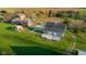An aerial view of the houses featuring a red barn and lush landscaping at 5752 River Rd, Waldron, IN 46182
