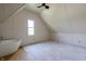 Attic featuring dormer window, carpeting, and high ceilings at 5752 River Rd, Waldron, IN 46182