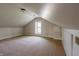 Carpeted attic space with a dormer window, offering potential for a bonus room or extra storage at 5752 River Rd, Waldron, IN 46182