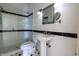 Bathroom featuring pedestal sink, framed mirror, and a shower with a glass door at 5752 River Rd, Waldron, IN 46182