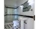 Elegant bathroom featuring a glass shower, pedestal sink, and black and white tile flooring at 5752 River Rd, Waldron, IN 46182