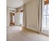 Bright bedroom with neutral carpet and white trim, featuring two windows and a hallway entry at 5752 River Rd, Waldron, IN 46182